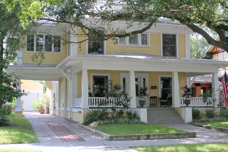 Front view with large porch and porte cochere