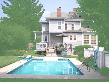 Back view, pool, deck, yard.