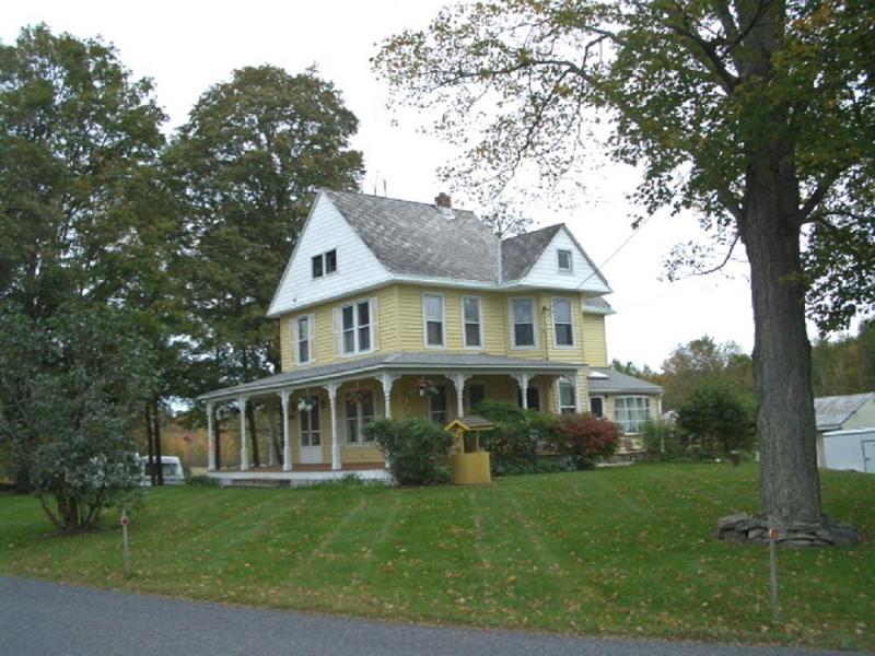 View from right showing bow window of sun room which opens onto patio