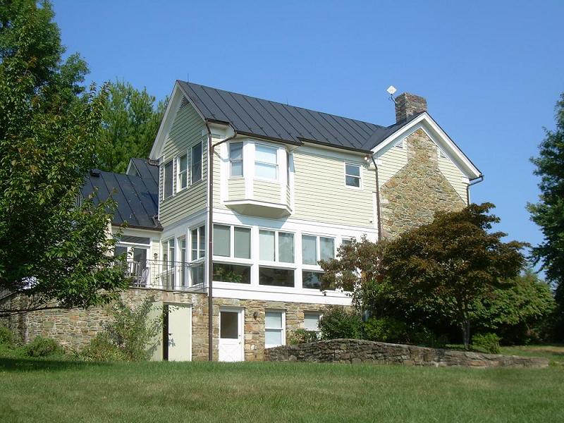 Side of the house showing frame and stone sections.