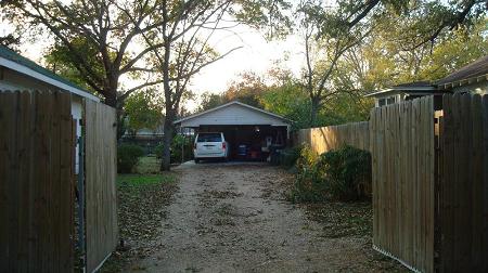 Carport behind privacy fence