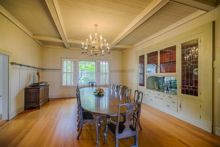 The formal dining room features a built-in buffet with leaded glass doors & coffered ceilings