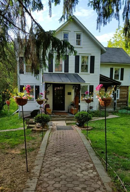 Colonial log house with Victorian additions on 41 acres