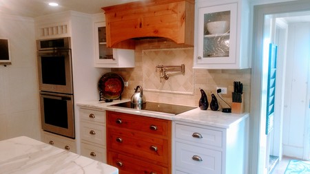 Gourmet kitchen with electric cooktop and wall ovens