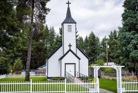 Front view of church with fence and trellis