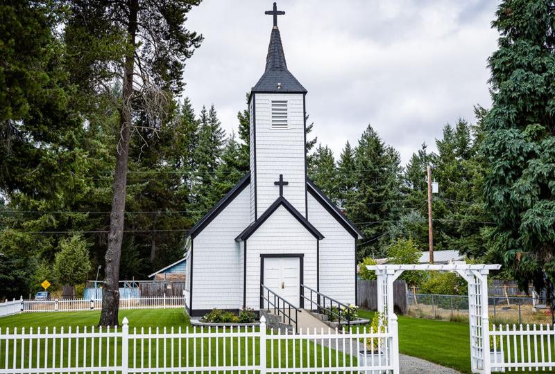 Front view of church with fence and trellis