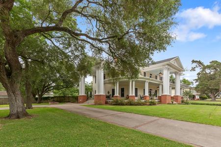 Expansive 1.01-acre corner lot adorned with mature trees and manicured landscaping.